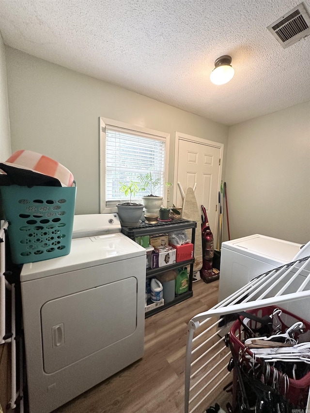 300 Michelle Ave, White Hall, AR 71602 - laundry room featuring independent washer and dryer, wood finished floors, and a textured ceiling