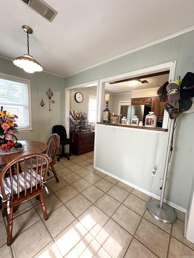 300 Michelle Ave, White Hall, AR 71602 - kitchen with a textured ceiling, ornamental molding, freestanding refrigerator, light tile patterned floors, and dark countertops