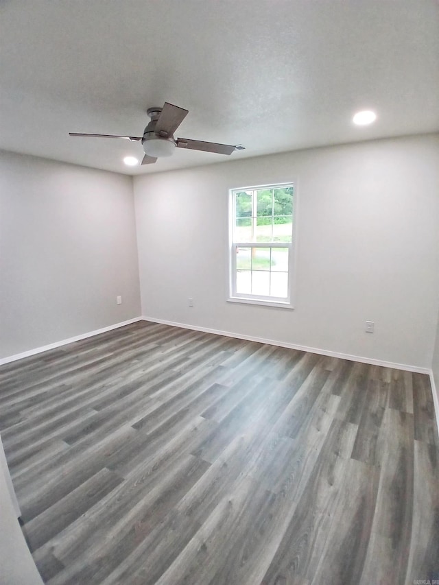 spare room with baseboards, ceiling fan, recessed lighting, and wood finished floors