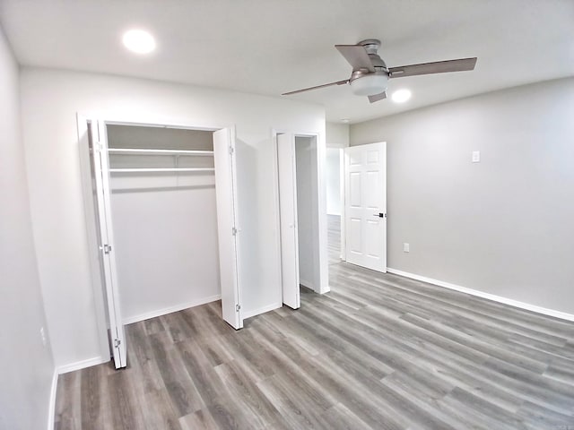 unfurnished bedroom featuring wood finished floors, baseboards, and ceiling fan