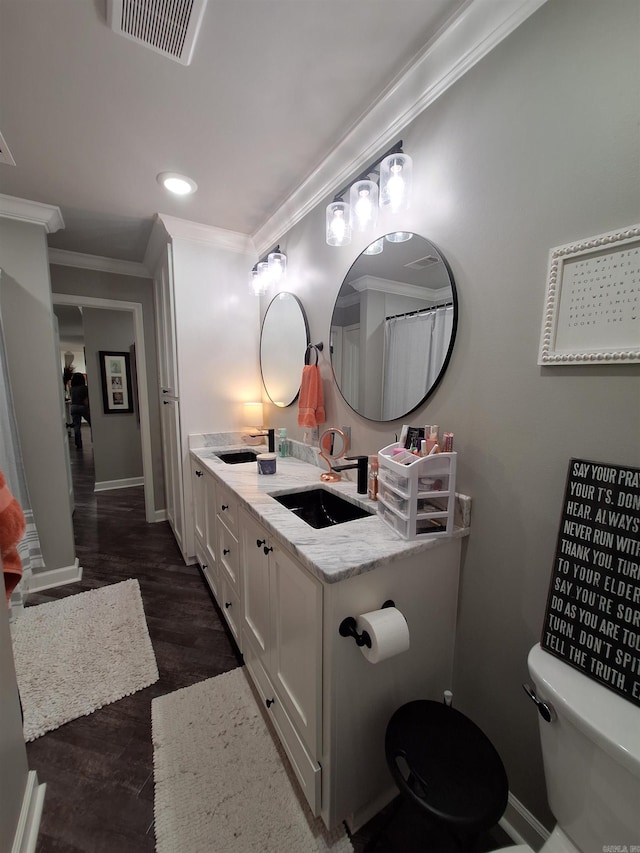 4401 Wagon Trace Cv, White Hall, AR 71602 - full bathroom featuring toilet, double vanity, ornamental molding, baseboards, and wood finished floors