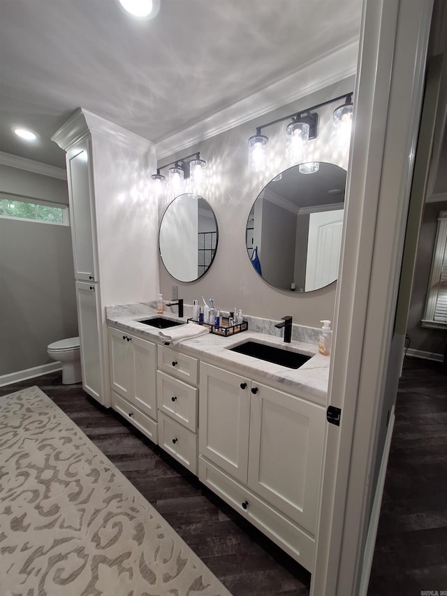 4401 Wagon Trace Cv, White Hall, AR 71602 - full bathroom with double vanity, crown molding, wood finished floors, toilet, and baseboards