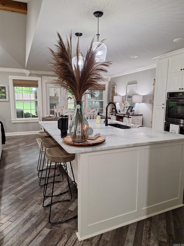 4401 Wagon Trace Cv, White Hall, AR 71602 - kitchen featuring crown molding, a sink, white cabinetry, dark wood-type flooring, and baseboards