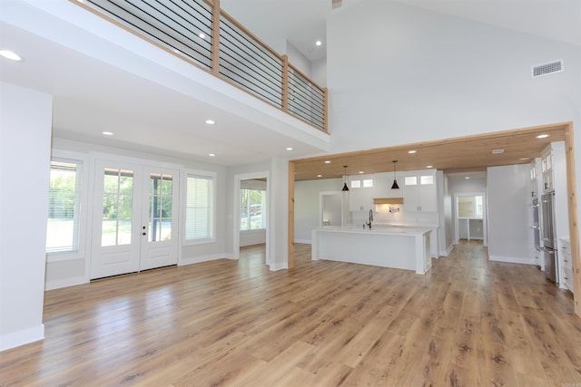 19300 Lake Winona Rd, Paron, AR 72122 - unfurnished living room featuring recessed lighting, light wood-style floors, a sink, baseboards, and french doors