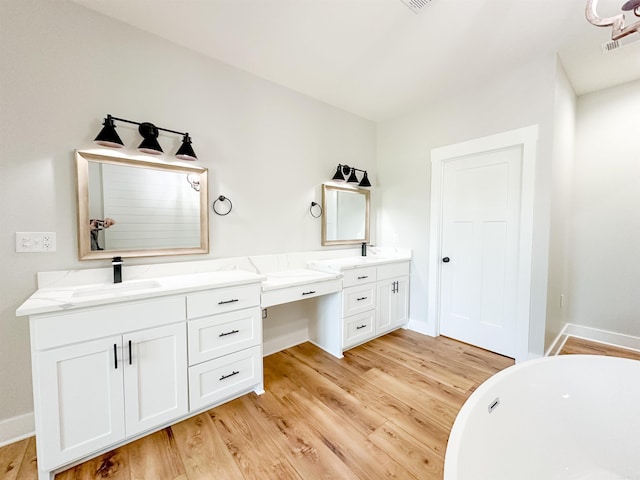 19300 Lake Winona Rd, Paron, AR 72122 - full bath featuring wood finished floors, double vanity, a freestanding bath, and baseboards