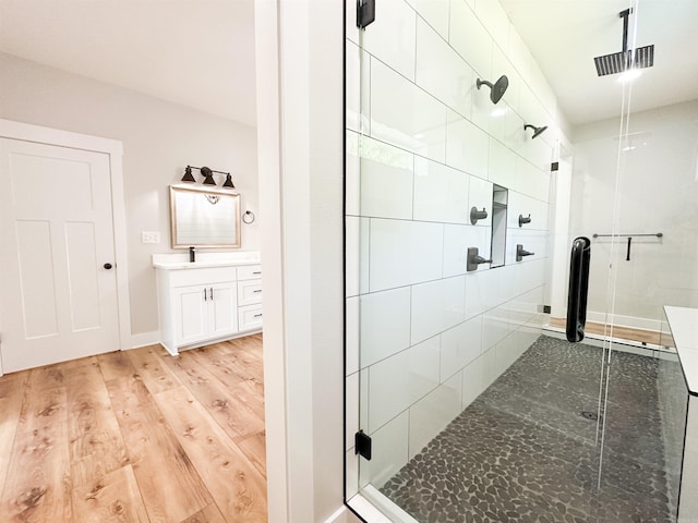 19300 Lake Winona Rd, Paron, AR 72122 - bathroom featuring a shower stall, vanity, wood finished floors, and baseboards