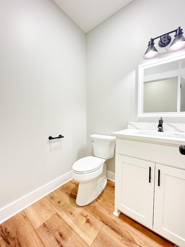 19300 Lake Winona Rd, Paron, AR 72122 - bathroom with toilet, vanity, wood finished floors, and baseboards