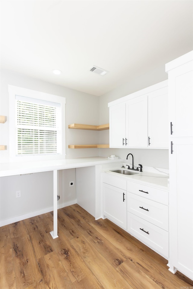 19300 Lake Winona Rd, Paron, AR 72122 - kitchen featuring a sink, light countertops, white cabinetry, open shelves, and light wood-style floors
