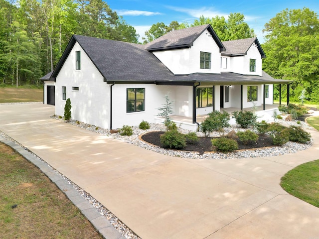 19300 Lake Winona Rd, Paron, AR 72122 - modern inspired farmhouse with a shingled roof, concrete driveway, covered porch, and a garage