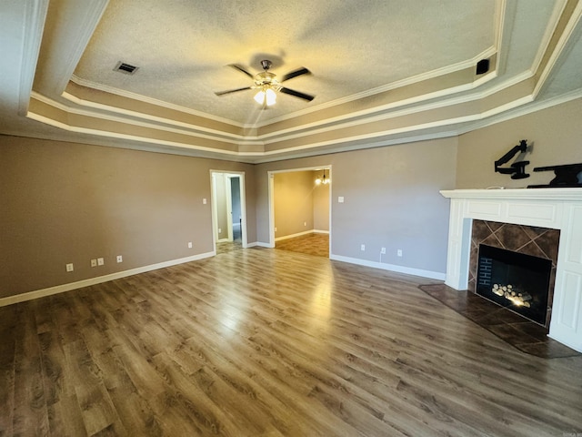 112 Seminole Cir, Austin, AR 72023 - unfurnished living room with a tray ceiling, crown molding, a ceiling fan, a premium fireplace, and wood finished floors