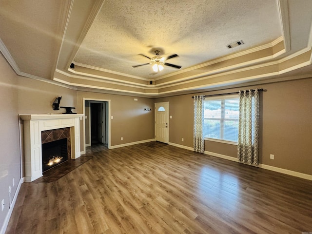112 Seminole Cir, Austin, AR 72023 - unfurnished living room with a raised ceiling, crown molding, ceiling fan, a textured ceiling, and a tiled fireplace