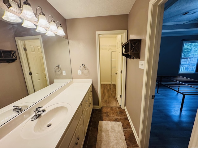 112 Seminole Cir, Austin, AR 72023 - bathroom featuring vanity, tile patterned floors, a chandelier, a textured ceiling, and a walk in closet