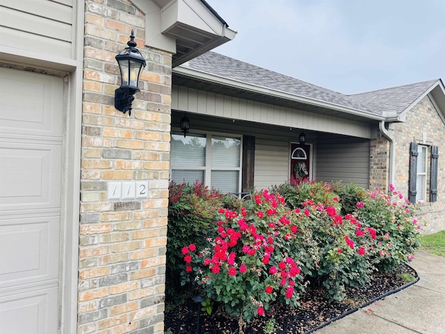 112 Seminole Cir, Austin, AR 72023 - entrance to property with roof with shingles, a porch, and brick siding