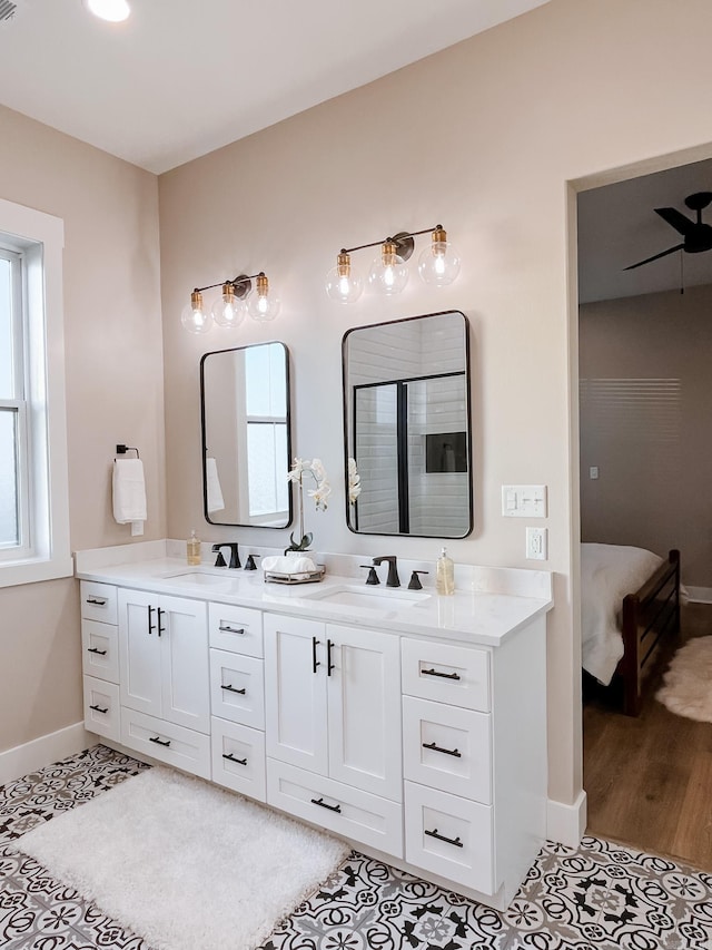 111 Legacy Way, Ward, AR 72176 - ensuite bathroom featuring double vanity, baseboards, and tile patterned floors