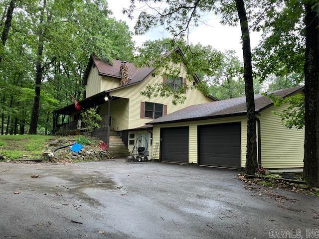 3244 Pyburn Ext, Pocahontas, AR 72455 - view of side of property featuring an attached garage, driveway, and stairs