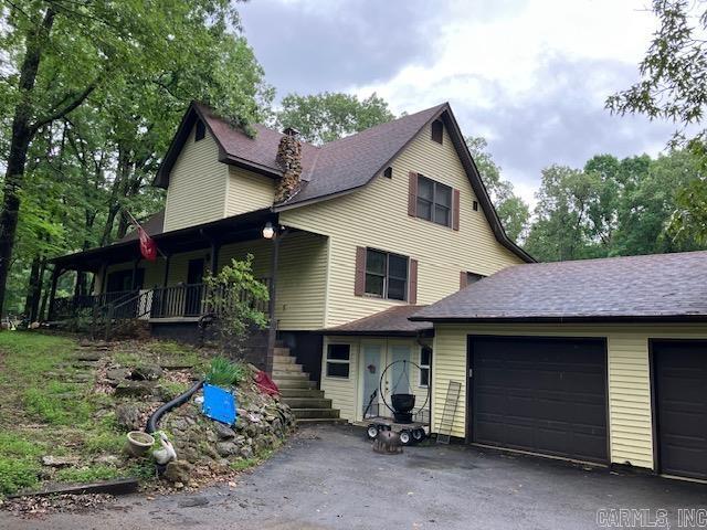 3244 Pyburn Ext, Pocahontas, AR 72455 - view of front of house featuring stairway, an attached garage, covered porch, a chimney, and driveway