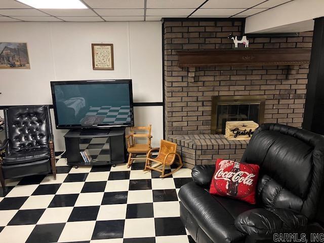 3244 Pyburn Ext, Pocahontas, AR 72455 - living area with a drop ceiling, tile patterned floors, and a brick fireplace