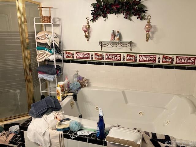 3244 Pyburn Ext, Pocahontas, AR 72455 - bathroom featuring a jetted tub and a shower with door