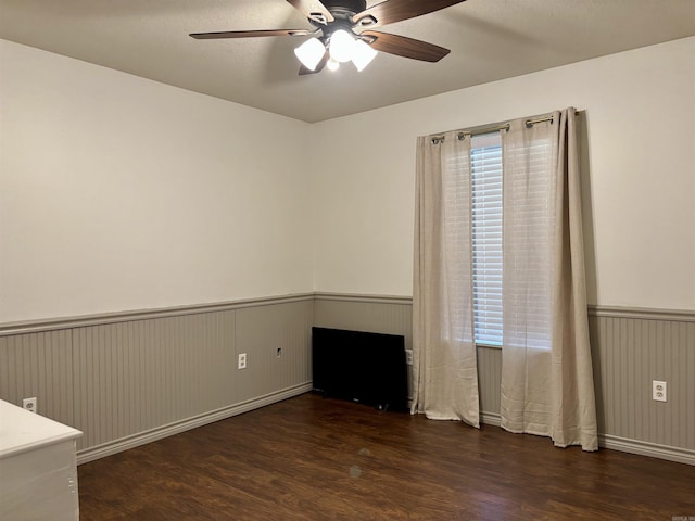 177 Timberlane, Dierks, AR 71833 - empty room with a wainscoted wall, wood finished floors, a ceiling fan, and plenty of natural light
