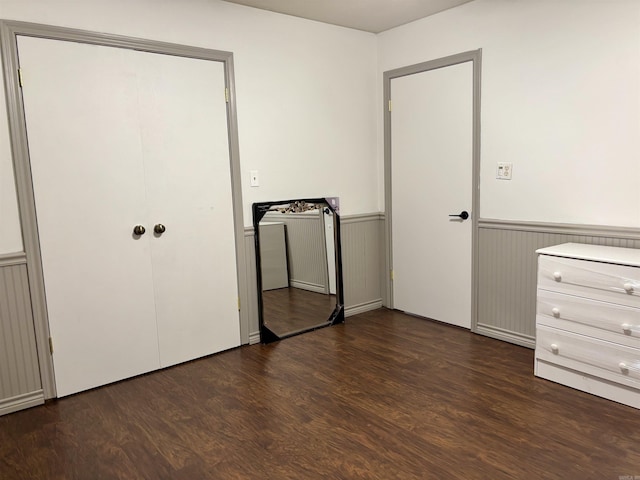177 Timberlane, Dierks, AR 71833 - unfurnished bedroom featuring wainscoting and dark wood finished floors