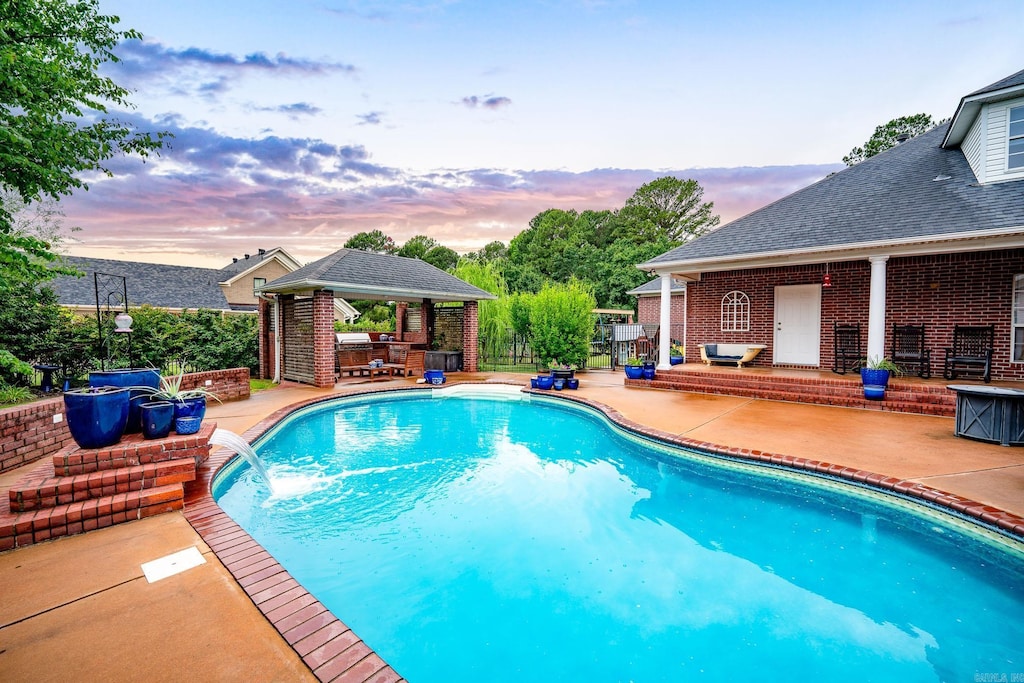 4545 Sawgrass Cv, Conway, AR 72034 - pool at dusk featuring a gazebo and a patio area