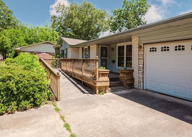 ranch-style home with asphalt driveway, a garage, and brick siding