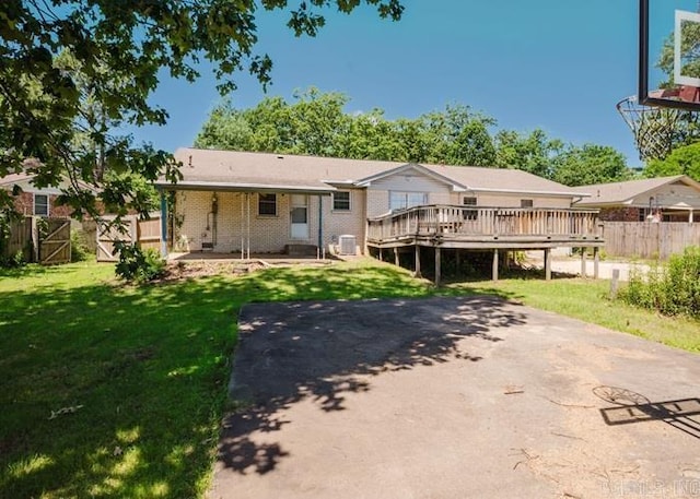 back of house featuring a wooden deck, central AC unit, and brick siding