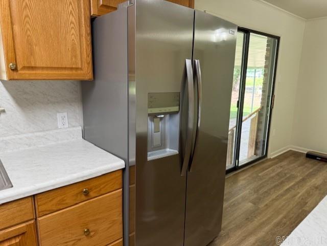 2275 Victory Ln, Conway, AR 72032 - kitchen featuring stainless steel refrigerator with ice dispenser, dark wood-style flooring, light countertops, backsplash, and brown cabinets
