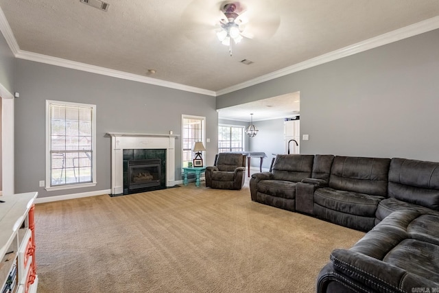 2960 Windamere Dr, Conway, AR 72034 - carpeted living room featuring ornamental molding, ceiling fan, a chandelier, baseboards, and a fireplace