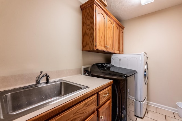2960 Windamere Dr, Conway, AR 72034 - laundry area with cabinet space, washer and dryer, light tile patterned floors, baseboards, and a textured ceiling