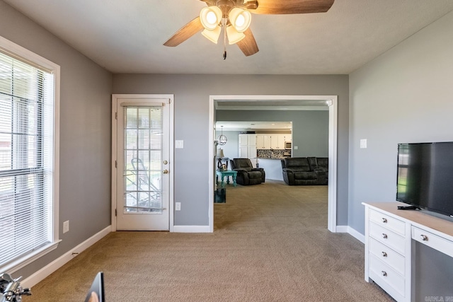 2960 Windamere Dr, Conway, AR 72034 - unfurnished living room featuring light colored carpet, a ceiling fan, plenty of natural light, and baseboards