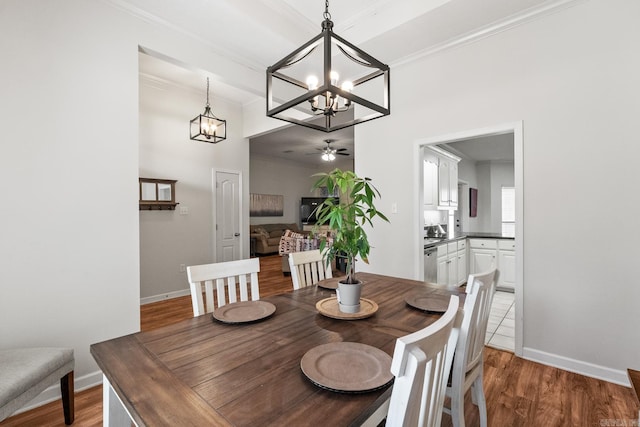 3720 Mcconnell Dr, Conway, AR 72034 - dining area featuring a chandelier, crown molding, a ceiling fan, wood finished floors, and baseboards