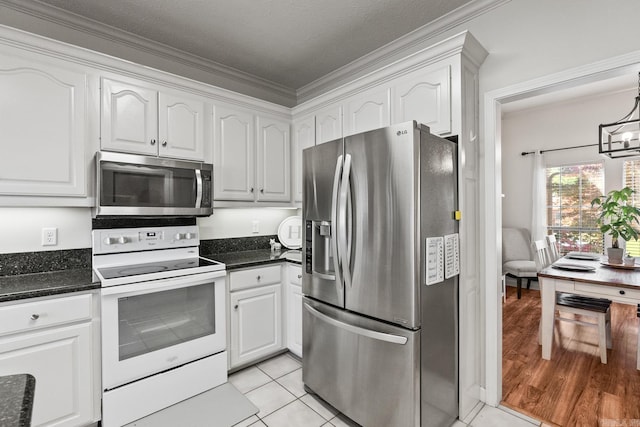 3720 Mcconnell Dr, Conway, AR 72034 - kitchen featuring appliances with stainless steel finishes, white cabinets, ornamental molding, light tile patterned flooring, and a chandelier