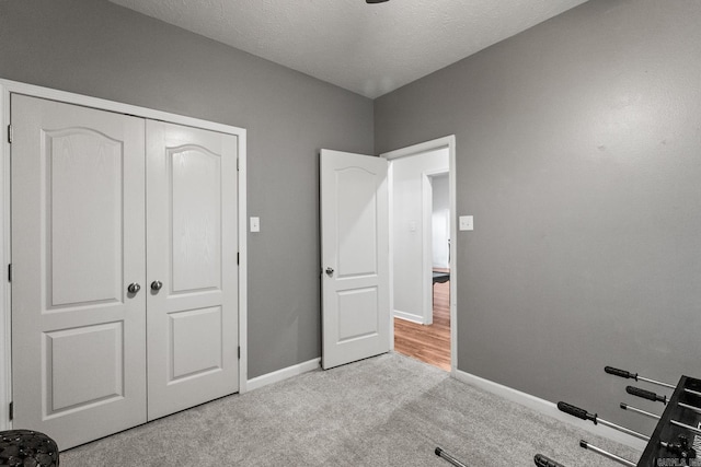 3720 Mcconnell Dr, Conway, AR 72034 - unfurnished bedroom featuring baseboards, carpet flooring, a closet, and a textured ceiling