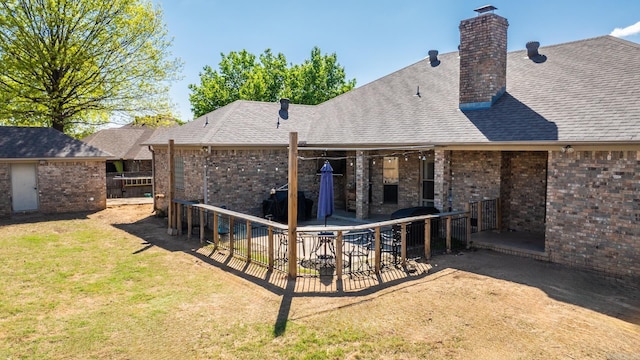 3720 Mcconnell Dr, Conway, AR 72034 - back of property with brick siding, a patio, a lawn, a chimney, and a shingled roof