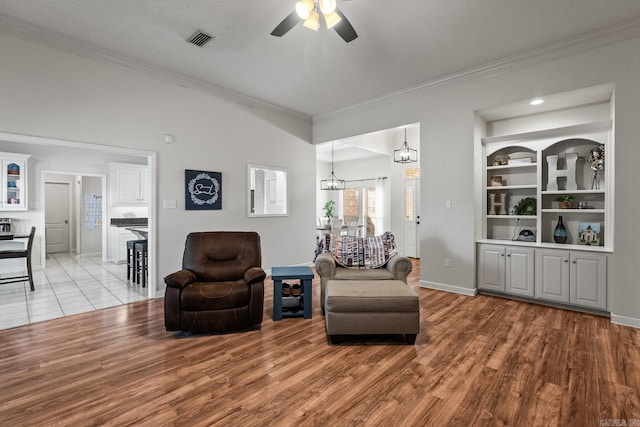 3720 Mcconnell Dr, Conway, AR 72034 - living area featuring ceiling fan, crown molding, light wood-style flooring, and baseboards