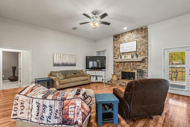 3720 Mcconnell Dr, Conway, AR 72034 - living room featuring ornamental molding, ceiling fan, a fireplace, and wood finished floors