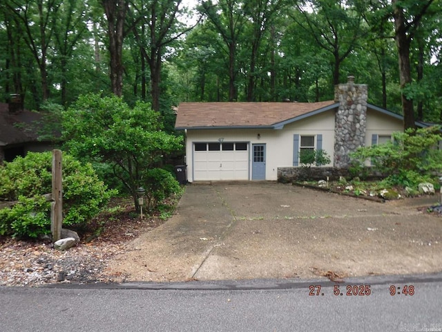 47 Segovia Dr, Hot Springs Village, AR 71909 - view of front of house with driveway, a garage, and a chimney
