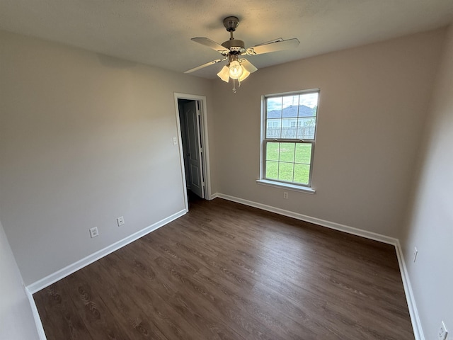 406 Apricot St, Austin, AR 72007 - unfurnished room featuring baseboards, dark wood-type flooring, and a ceiling fan