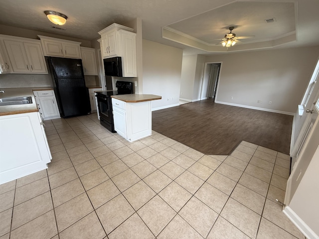 406 Apricot St, Austin, AR 72007 - kitchen featuring black appliances, a ceiling fan, a sink, light tile patterned flooring, and a raised ceiling