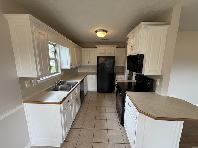 406 Apricot St, Austin, AR 72007 - kitchen featuring black appliances, a sink, a peninsula, decorative backsplash, and a textured ceiling