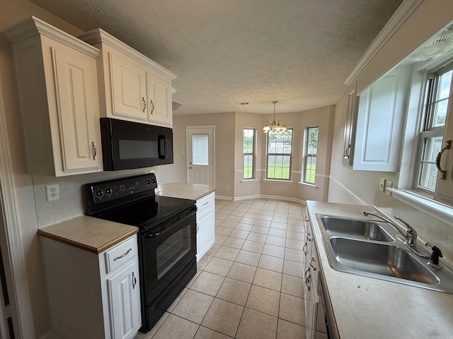 406 Apricot St, Austin, AR 72007 - kitchen featuring black appliances, light tile patterned floors, a chandelier, a sink, and a textured ceiling