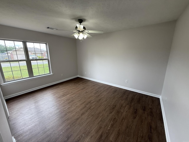 406 Apricot St, Austin, AR 72007 - empty room featuring dark wood finished floors, ceiling fan, baseboards, and a textured ceiling