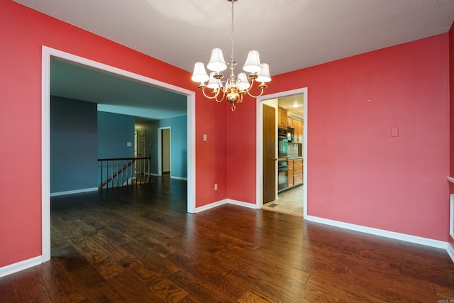 3400 Millbrook Rd, Little Rock, AR 72227 - spare room with wood finished floors, a chandelier, and baseboards