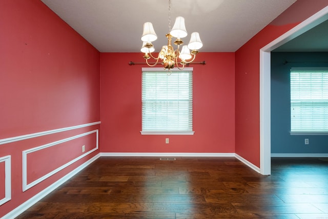 3400 Millbrook Rd, Little Rock, AR 72227 - unfurnished room featuring a chandelier, wood finished floors, healthy amount of natural light, and baseboards