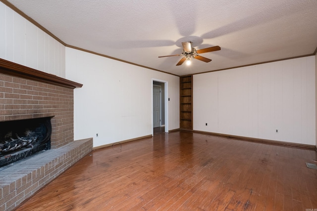3400 Millbrook Rd, Little Rock, AR 72227 - unfurnished living room featuring ornamental molding, a ceiling fan, a brick fireplace, wood finished floors, and baseboards