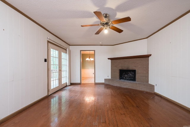 3400 Millbrook Rd, Little Rock, AR 72227 - unfurnished living room with ornamental molding, wood-type flooring, a chandelier, a brick fireplace, and baseboards