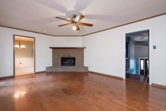 3400 Millbrook Rd, Little Rock, AR 72227 - unfurnished living room featuring crown molding, wood-type flooring, a chandelier, a ceiling fan, and a brick fireplace