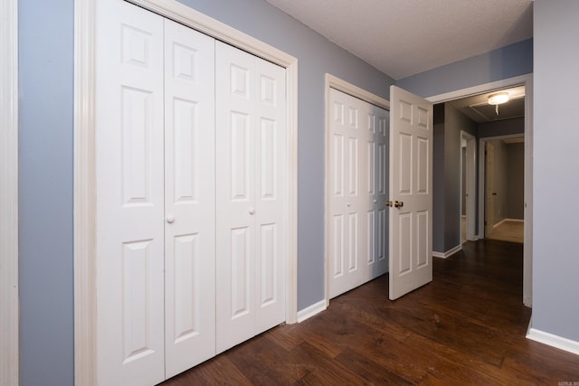 3400 Millbrook Rd, Little Rock, AR 72227 - unfurnished bedroom with dark wood-style floors, multiple closets, baseboards, and attic access