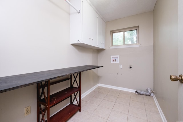 3400 Millbrook Rd, Little Rock, AR 72227 - laundry room with cabinet space, hookup for an electric dryer, hookup for a washing machine, baseboards, and light tile patterned floors